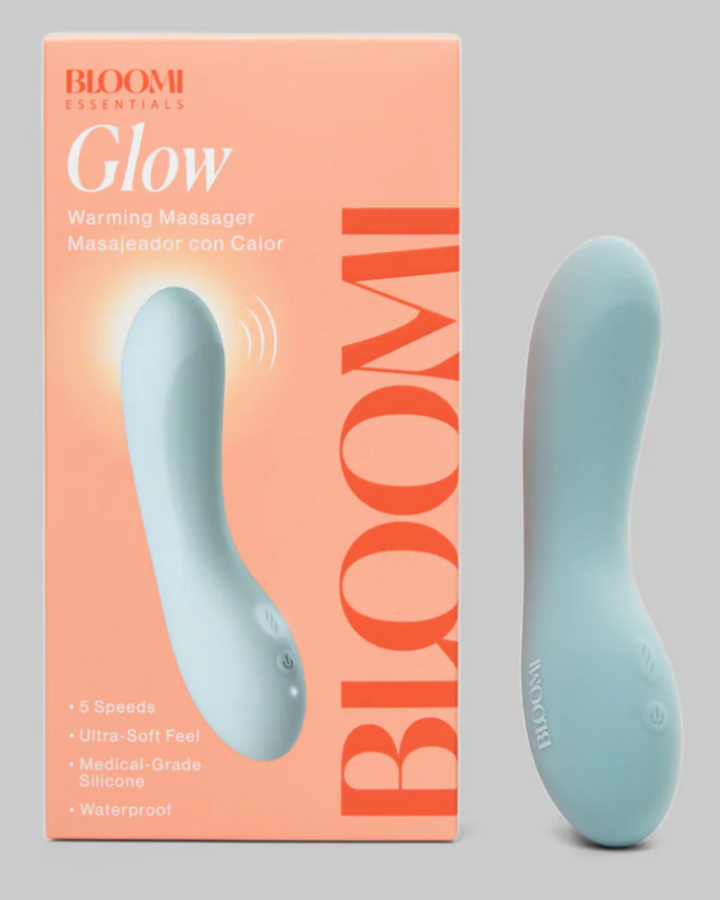Bloomi Glow warming massager with packaging on a gray background