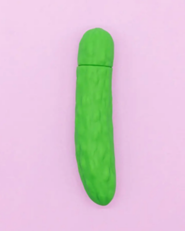 Green cylindrical object on a light purple background