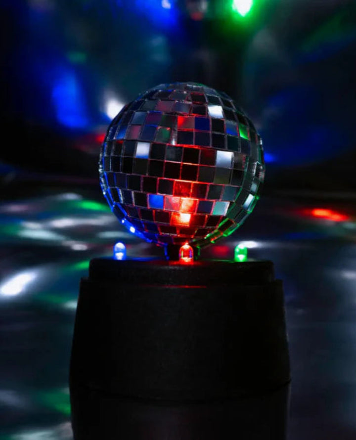 Discoball with colorful lights on a dark background