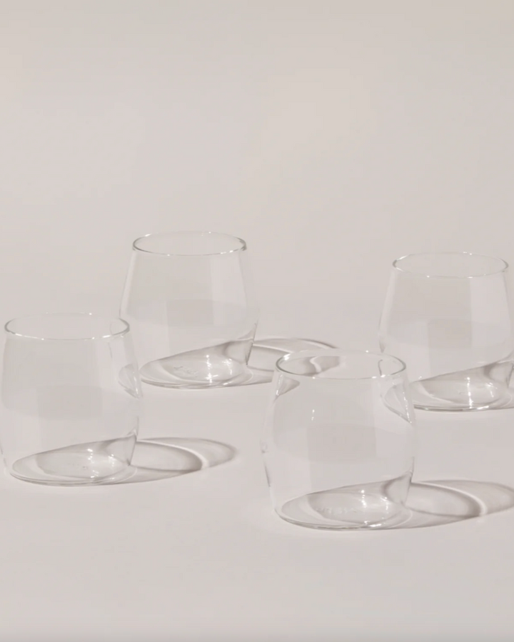 Set of clear glass tumblers on a light gray background