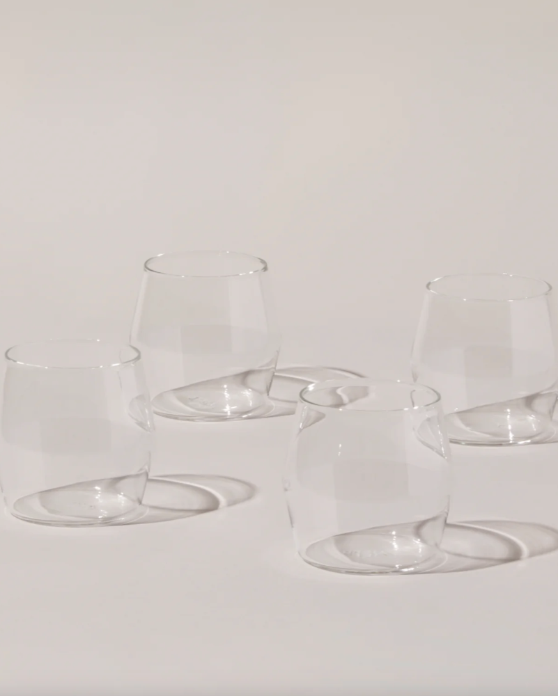 Set of clear glass tumblers on a light gray background