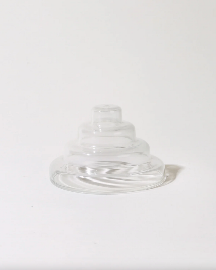 Clear glass saucer on a white background