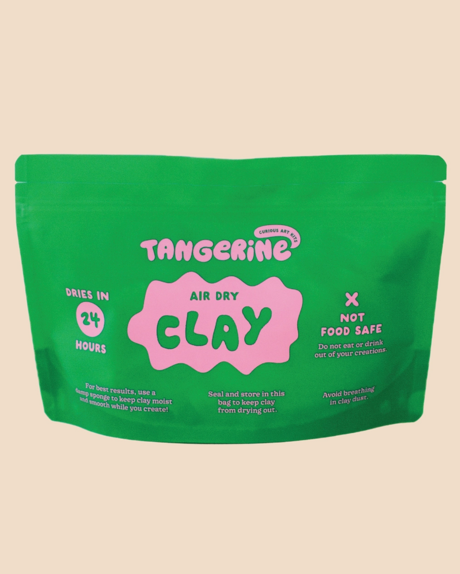Green package of Tangerine Air Dry Clay on a beige background