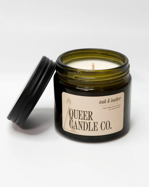 Candle in a jar with 'Queer Candle Co.' label on a white background