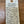 Handwritten product description tag on a wooden surface