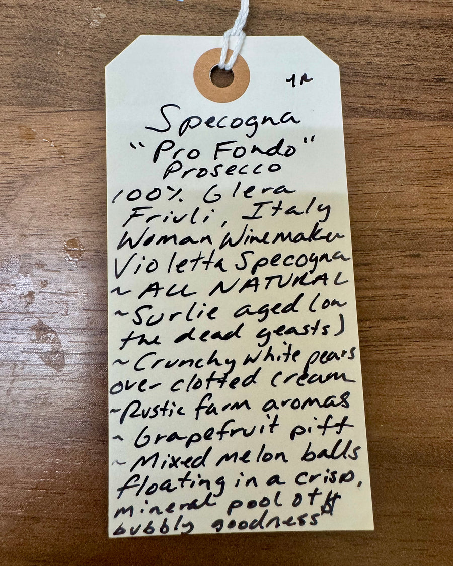 Handwritten product description tag on a wooden surface