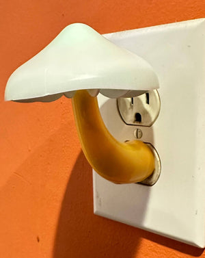 Super cute mushroom light! This nightlight plugs directly into any wall outlet. The mushroom light slowly cycles through different colors on its own. They give just enough light to keep from bumping into walls. The mushroom cap measures 3.25" in diameter & approx. 4.5" tall.