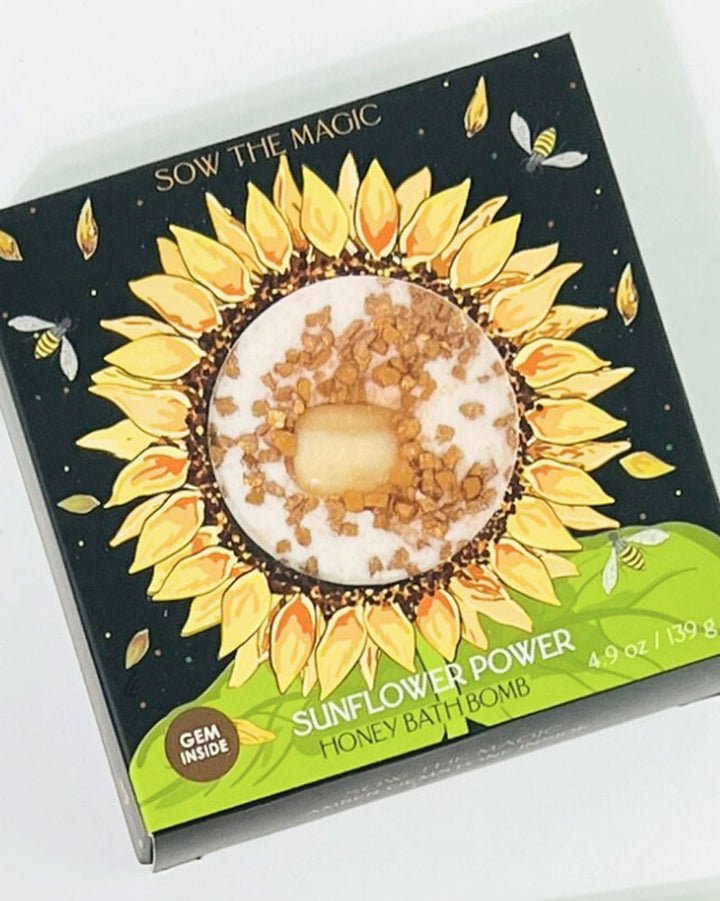 Sunflowers in global folklore are sacred symbols of loyalty as they follow the sun from East to West each day. Unwind and soak away with this honey scented bath bomb featuring Epsom Salt to revive sore muscles. Amber gemstone inside releases bright, soothing energy to calm the mind and soul. Directions: Open and place bath bomb under running water. Steep in bath for as long as desired. Amber gemstone inside.