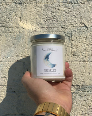 Hidden inside is a Moonstone that increases your intuition and connects you to the moon's energy to inspire new beginnings. Once your candle has burned retrieve your crystal and carry it with you, or place it in a sacred space to bring good fortune within the flow of your life. Hand-poured and made with 100% American farmed soy wax, the natural essential + fragrance oil blend features notes of citrus and sweet fruit. • 9 oz Jar • 50 HR Burn Time