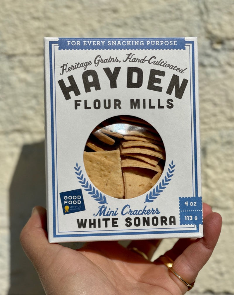 Jeff and Emma Zimmerman, a father-daughter duo, started Hayden Flour Mills in response to their desire to have flavorful and unmodified flour. Working with local farmers, they have re-introduced ancient and heritage grains into their products. By using a stone-milling technique, the most nutritious parts of the grain are retained for optimal tasty results. In addition to the delicious and healthy products, Hayden Flour Mills is proud to boast of being the only solar-powered stone mill in the US!