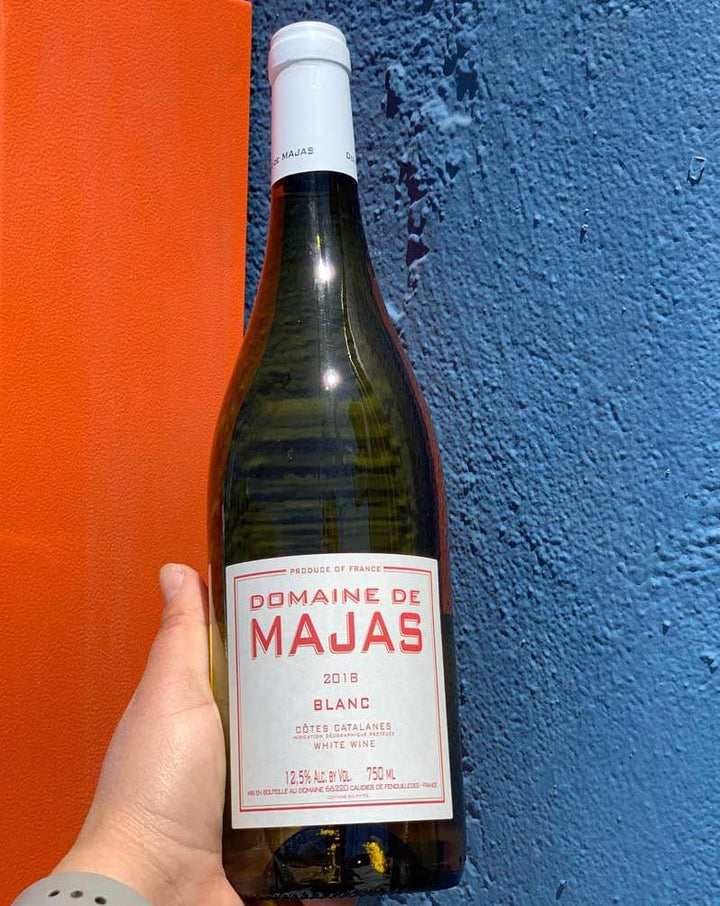 Domaine de Majas Blanc wine 45% Macabeu, 45% Rolle, 10% Carignan Blanc Côtes Catalanes, France.  Woman winemaker - Agnés Carréve. All natural. Fresh + juicy like a summer peach in the sun matched with a briny + flint-like minerality. Limestone, chalk, olives + zest!