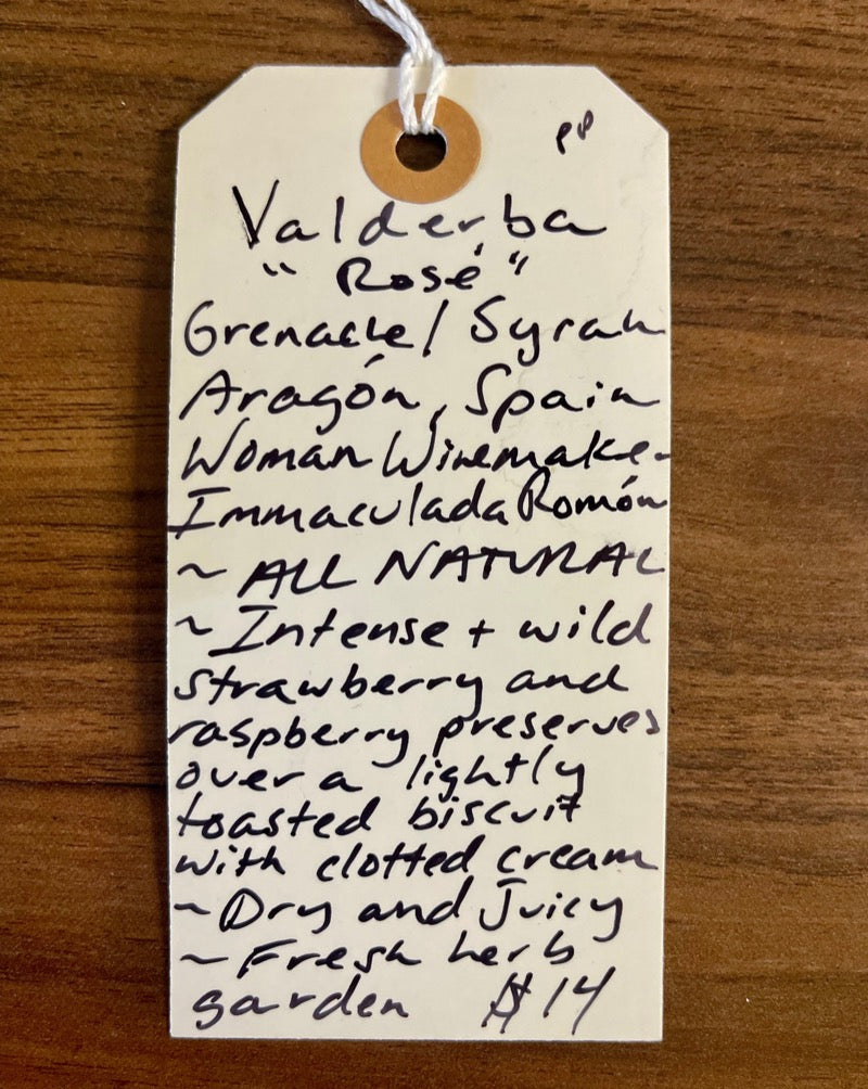 Grenache/Syrah Aragón, Spain.  Woman winemaker - Immaculada Romón. Intense and wild strawberry and raspberry preserves over a lightly toasted biscuit with clotted cream. Dry and juicy. Fresh herb garden.
