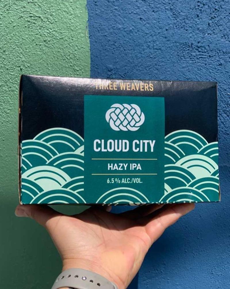 Three Weavers "Cloud City" Hazy IPA beer Inglewood, California.  Woman brewers - Alexandra Nowell, Lynne Weaver. 12 pack. 6.5% ABV. This hazy IPA is soft on the palate and blazing bright with aromas of peaches, mangoes, and sunny citrus fruits. Take a trip with us to Cloud City, where the forecast is always juicy with a chance of haze.